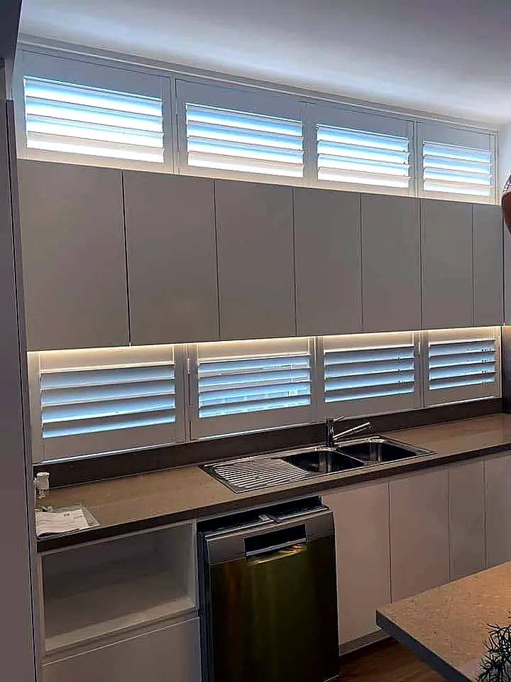 White plantation shutters installed in a modern Brisbane kitchen